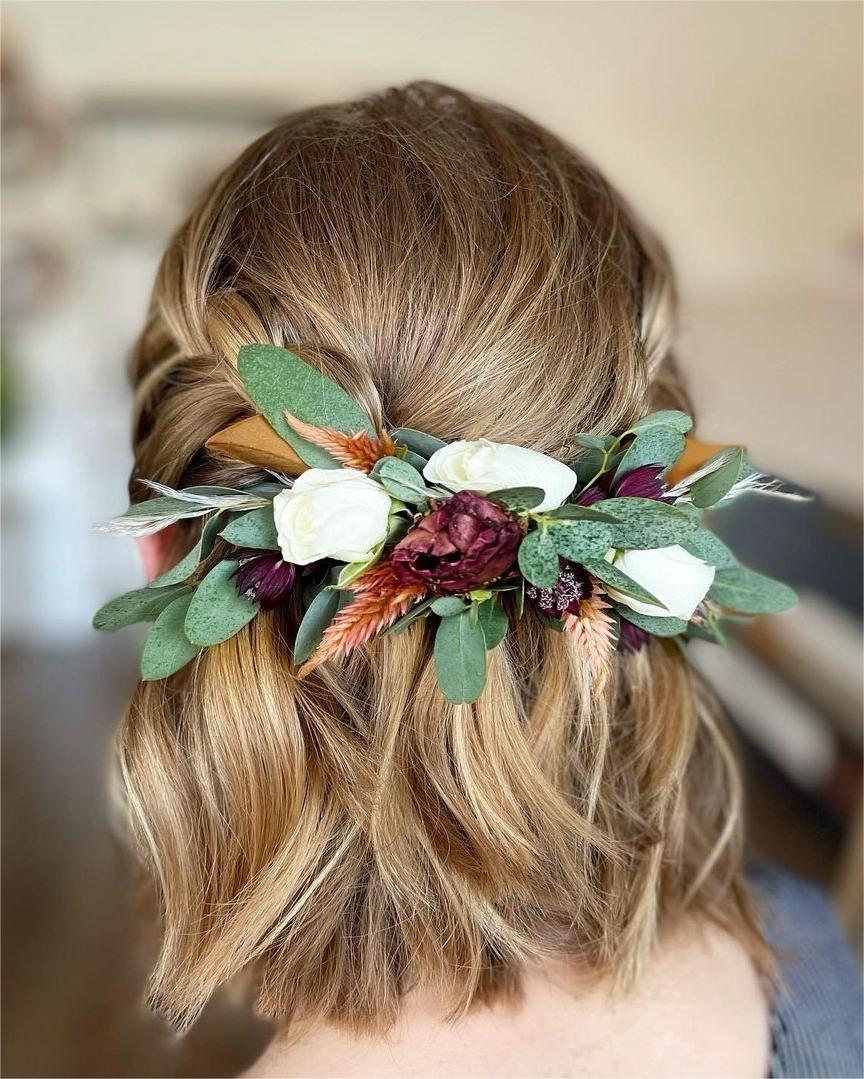 half up half down short prom hairstyle with greenery via troianeyoung