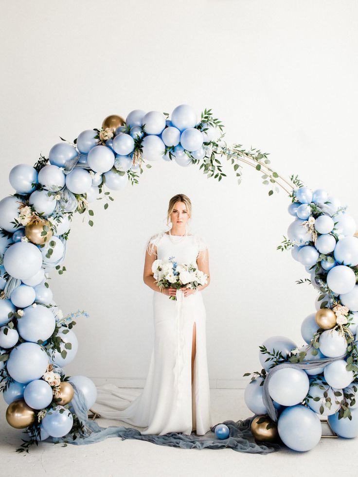 light blue and gold wedding arch with ballons