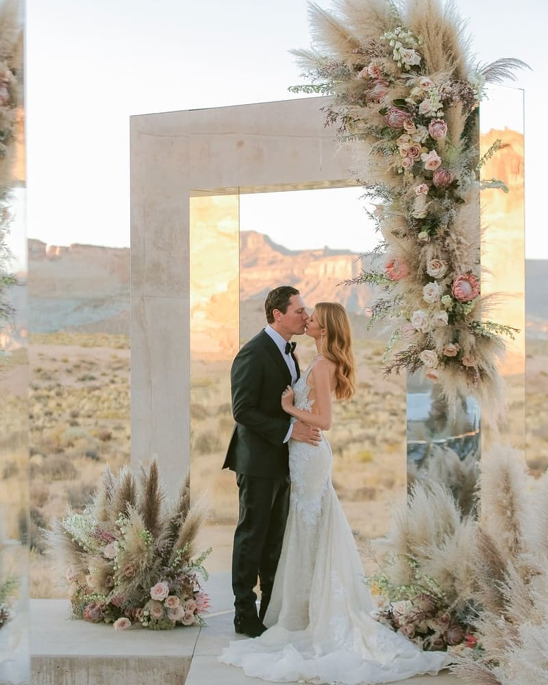 rustic bohemian mirror wedding backdrop with pampas grass via partyslate