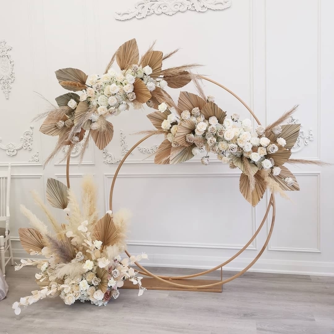 rustic boho circle wedding arch with dried palm leaves and pampas grass