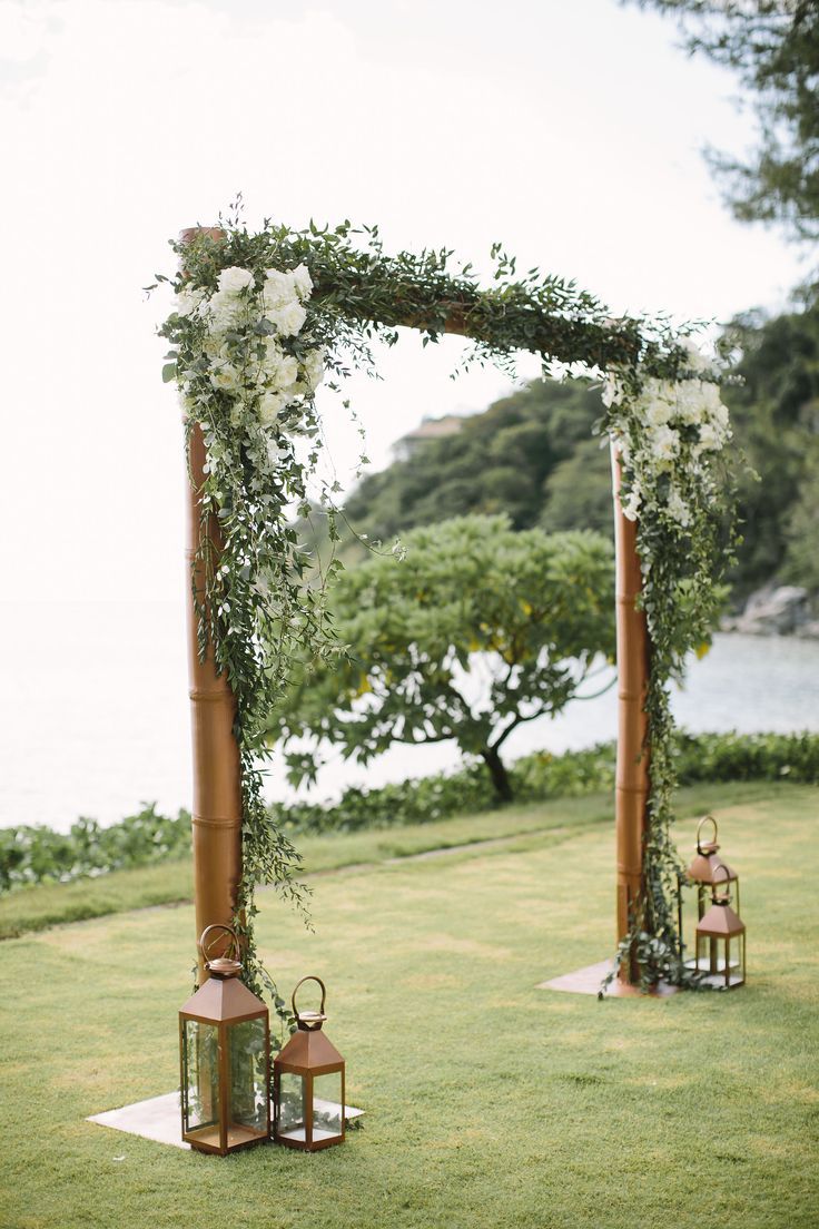 rustic simple greenery metal wedding arch with lanterns
