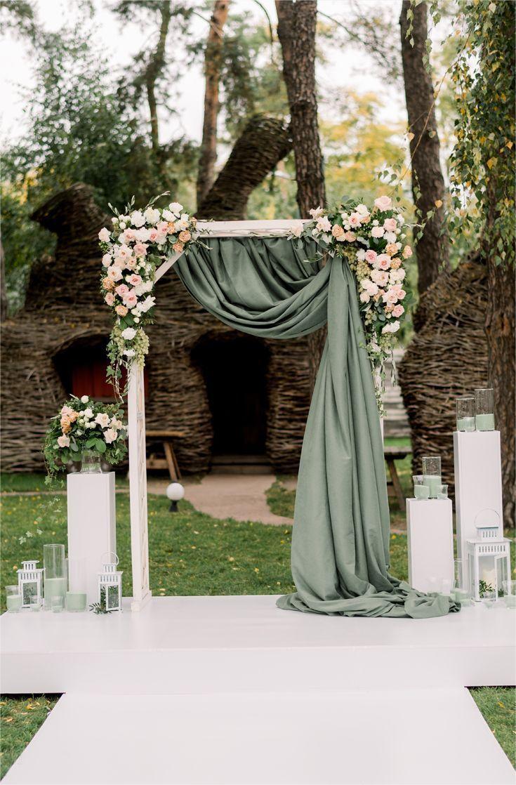 rustic simple sage green wood wedding arch with fabric