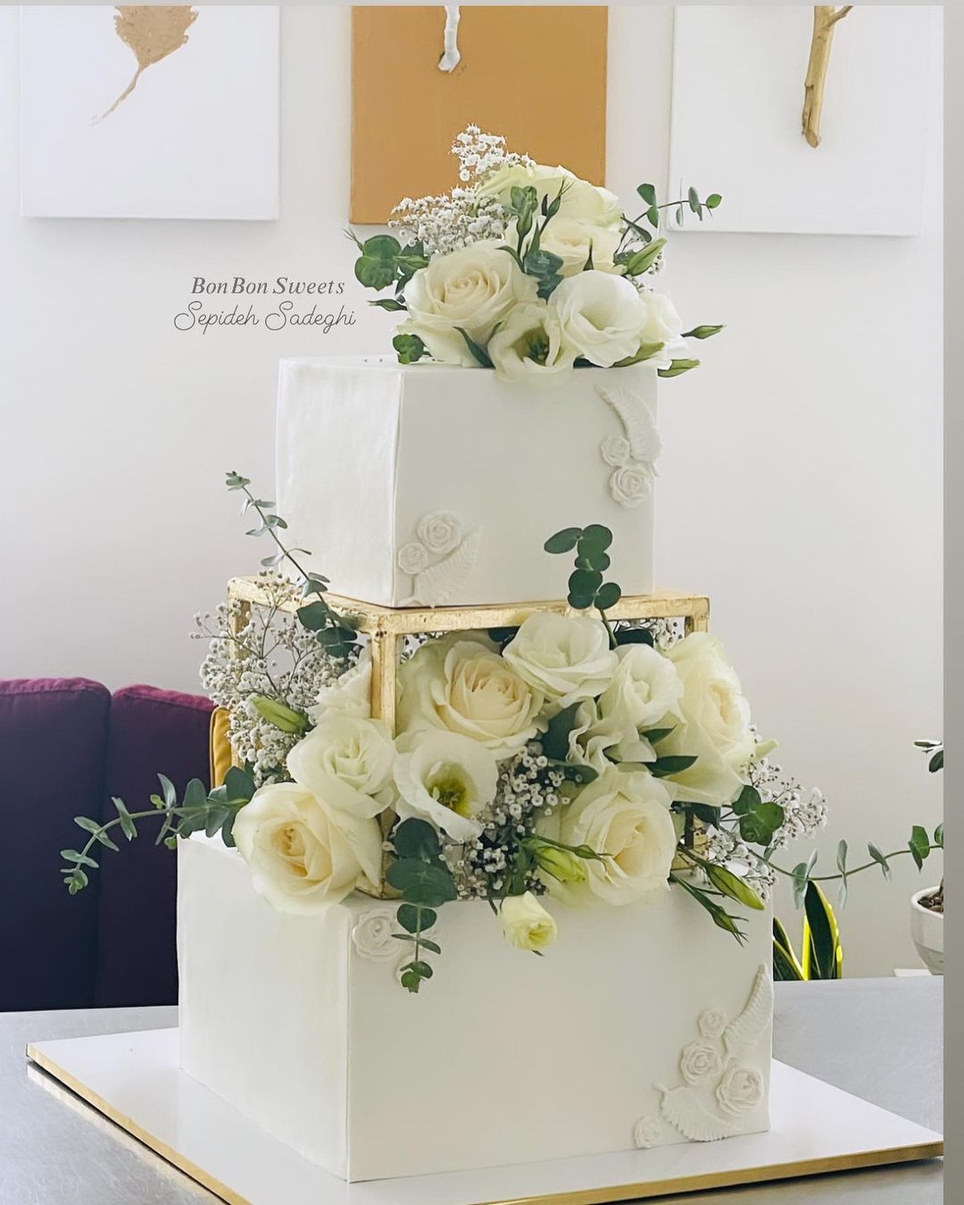 simple white square wedding cake with white roses and greenery via bonbon_sweets_yazd