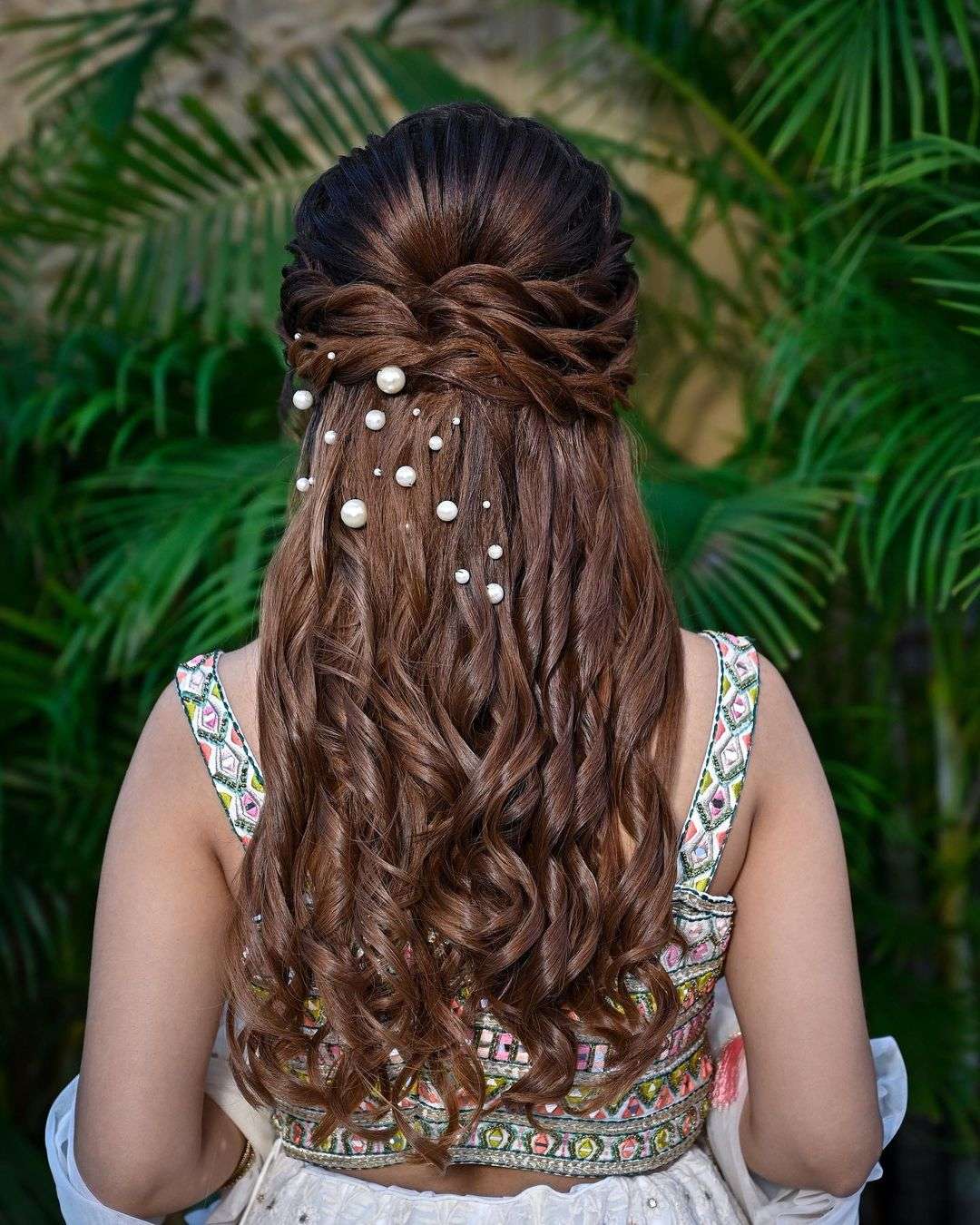 twisted curly half up half down indian wedding hairstyle via aayushimakeup