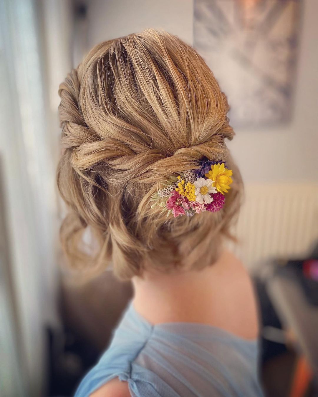 twisted short prom hairstyle with flowers via thehairbookweddingstylist