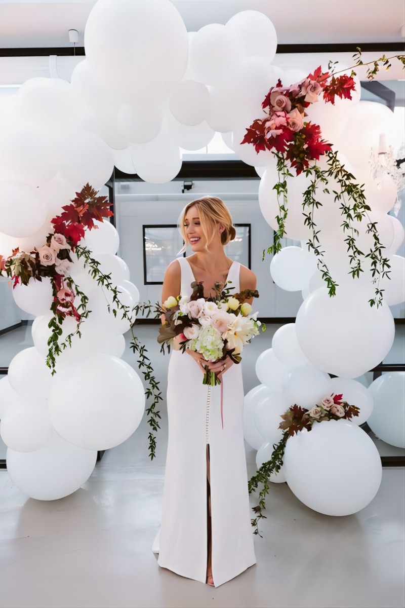 white balloon wedding arch with flowers