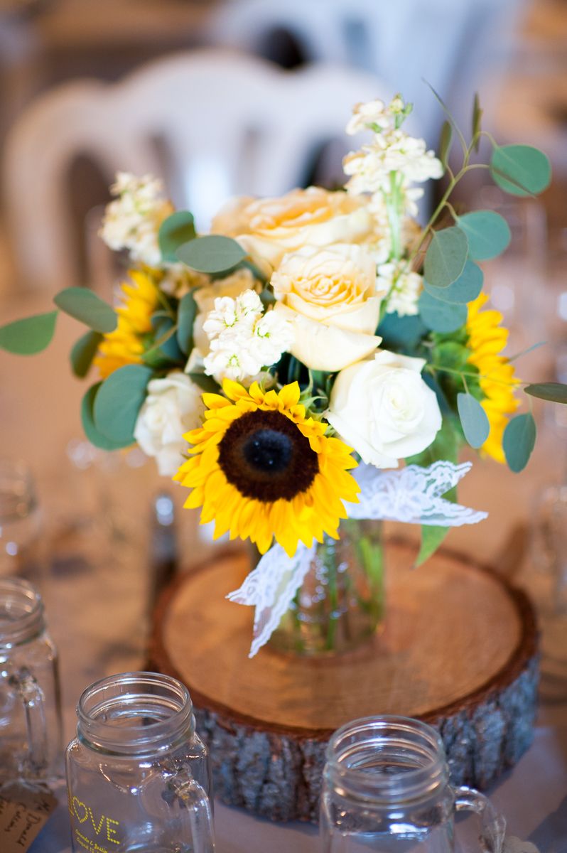 eucalyptus garland centerpiece with sunflowers and mason jars