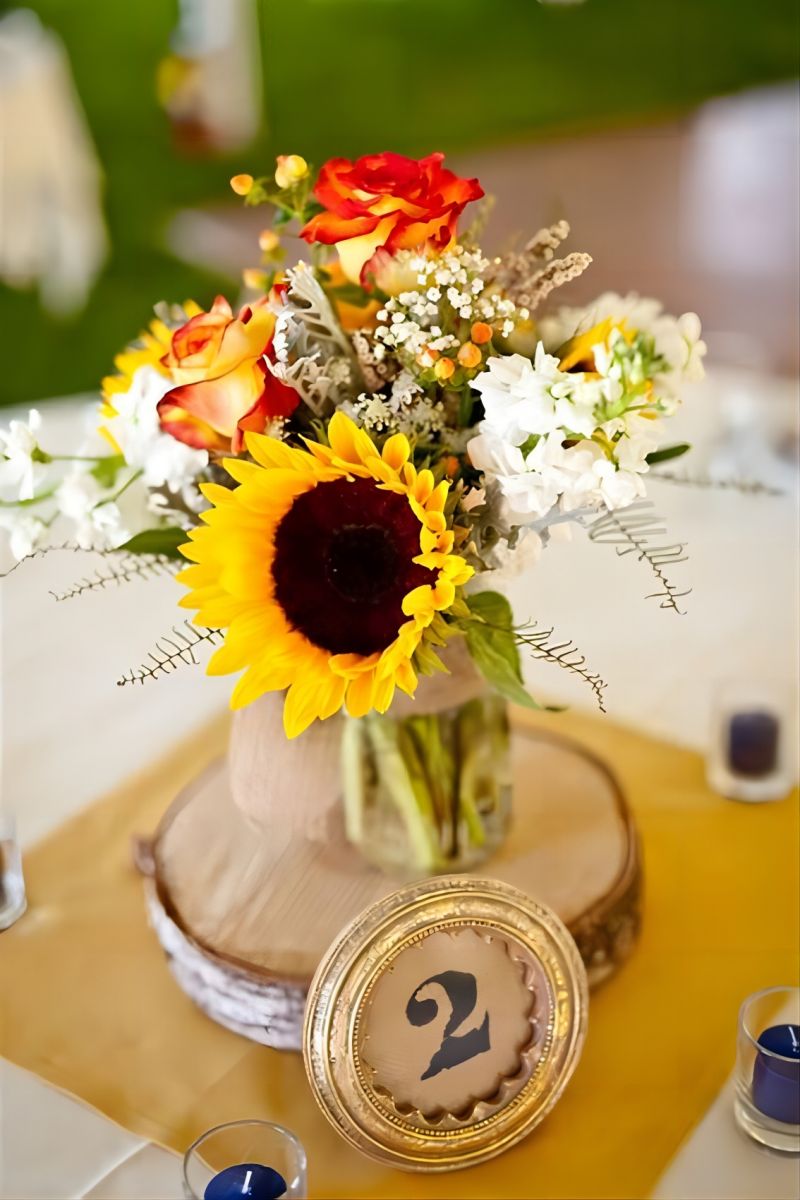 rustic fall sunflowers and wood slice wedding centerpiece