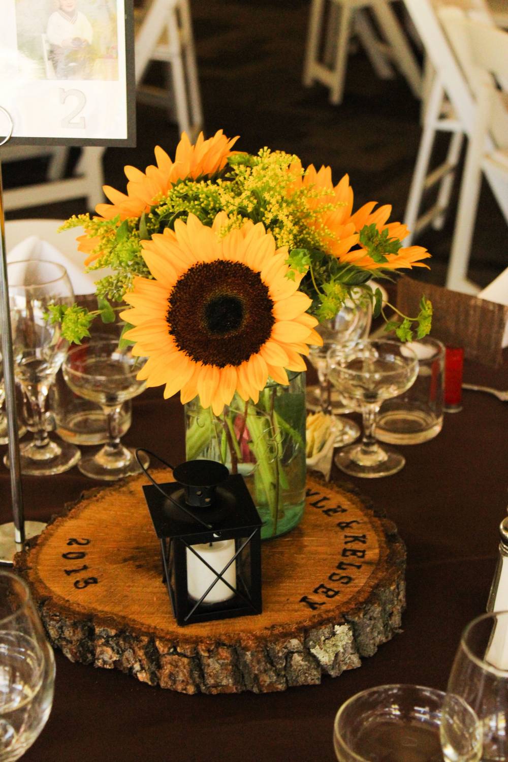 rustic sunflowers and tree stump wedding centerpiece