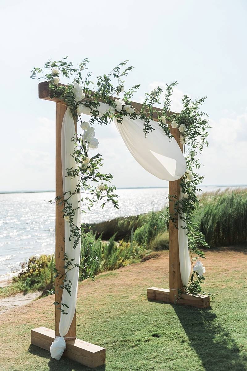 simple wooden and greenery wedding arch