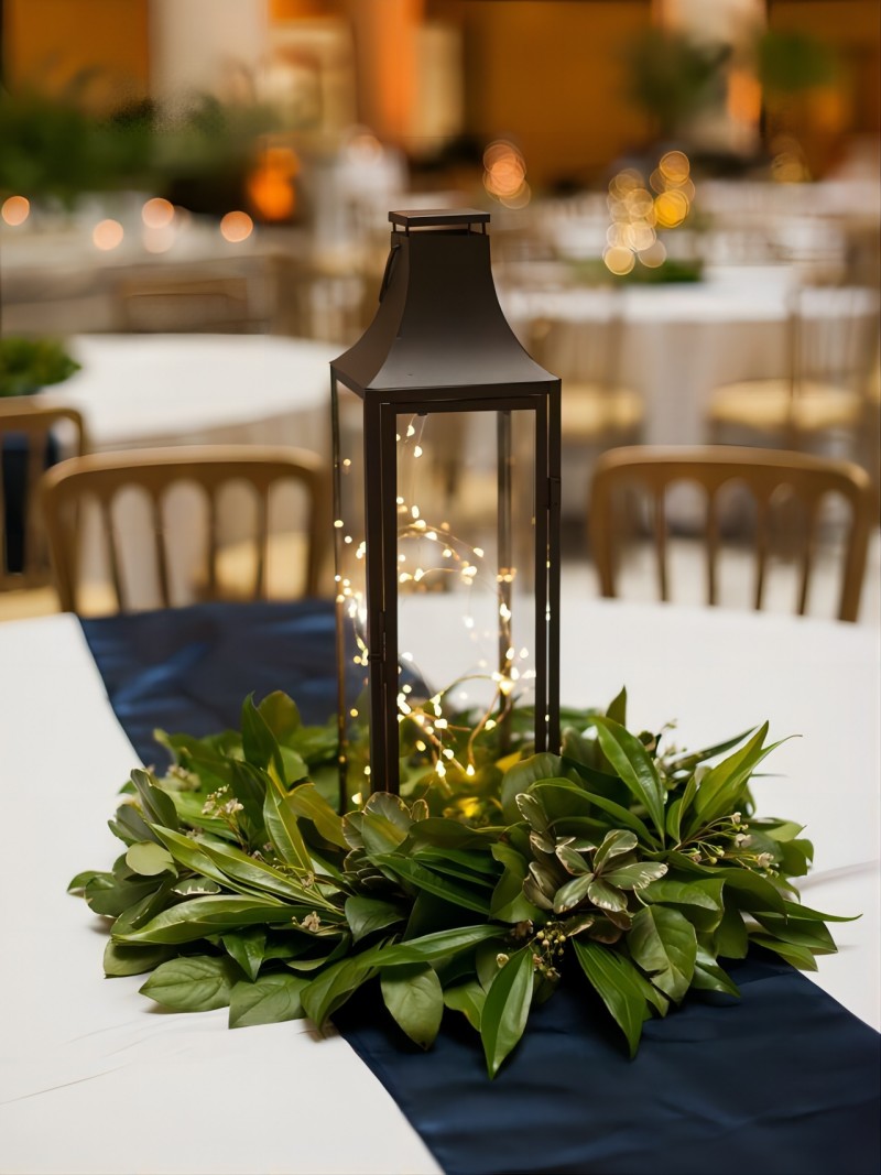 Black Lantern with Greenery and Lights Wedding Centerpiece