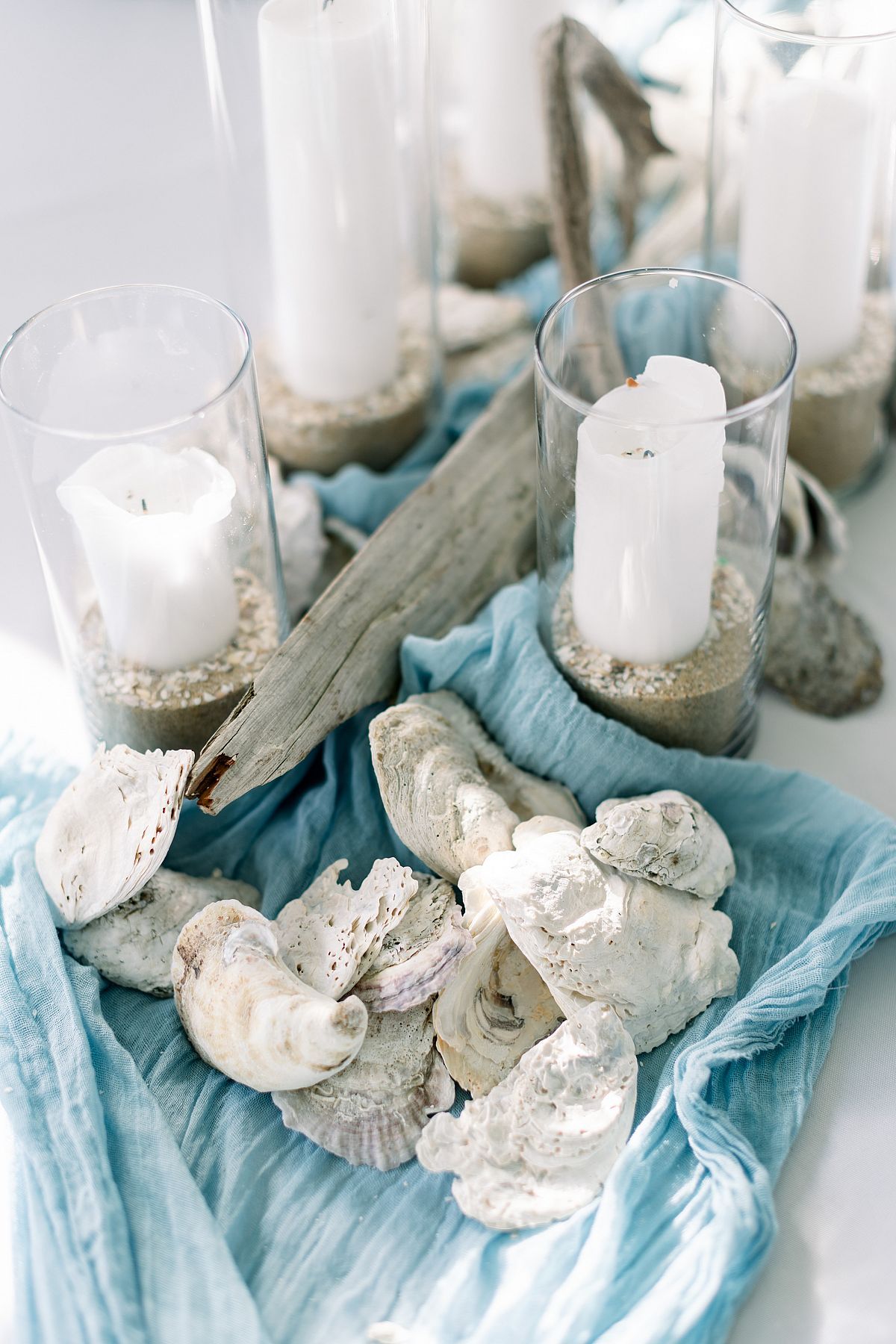 blue beach driftwood and candle wedding centerpiece