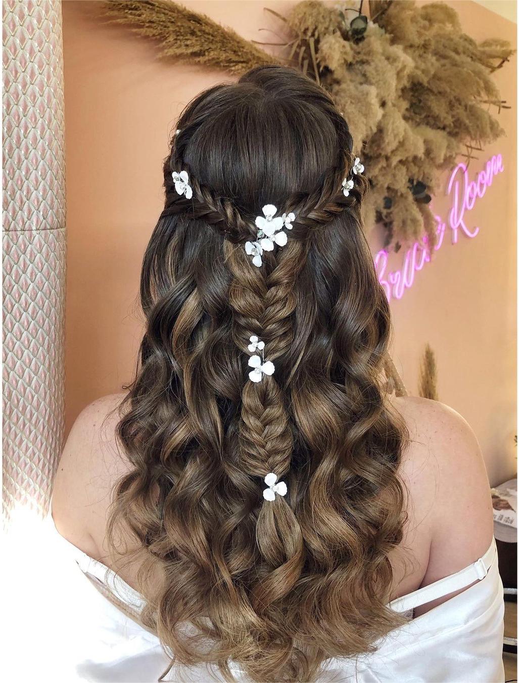 boho fishtail braided half up half down prom hairstyle with flowers via zhanna_syniavska