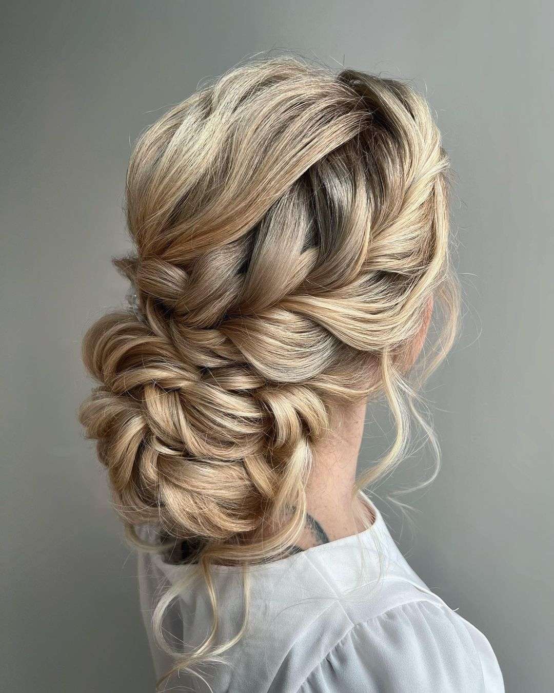 braided messy low bun updo wedding hairstyle via cathrineheierenhansen