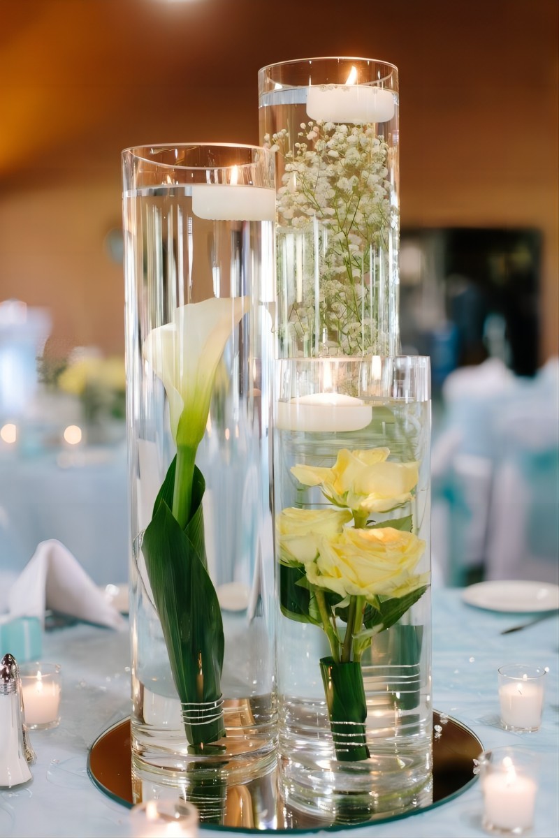 floating candles and cally lily yellow roses and baby's breath wedding centerpiece with mirror