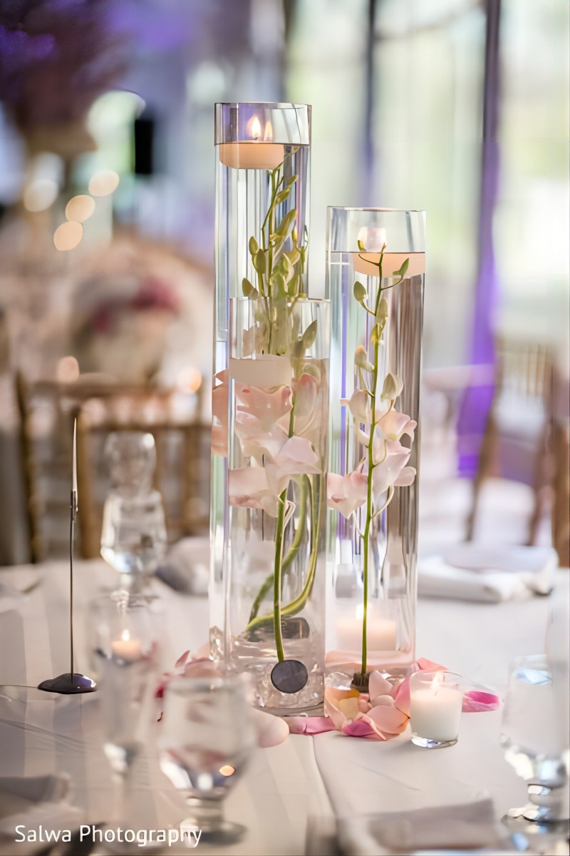 floating candles and pink orchids wedding centerpiece