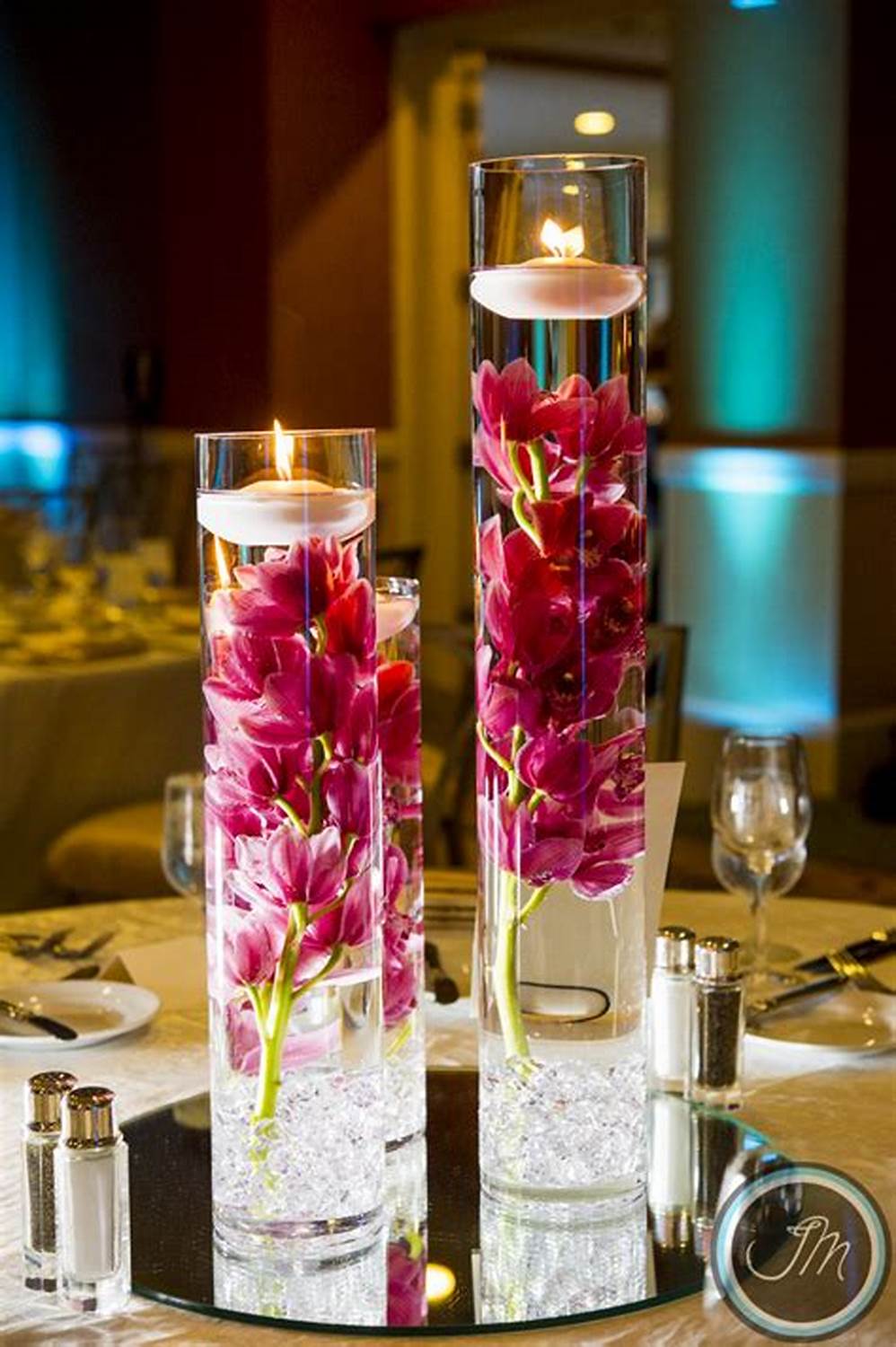 floating candles and viva magenta orchid wedding centerpiece