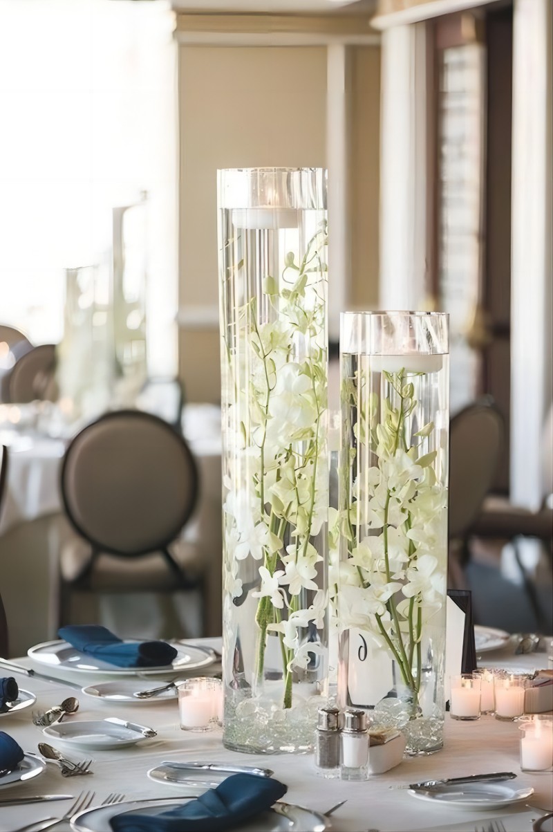 floating candles and white orchids wedding centerpiece