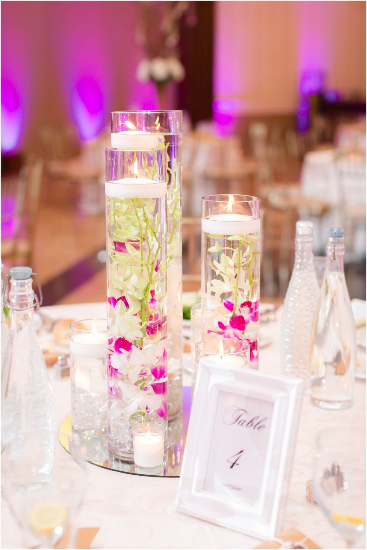 floating pink and white orchid wedding centerpiece with candles
