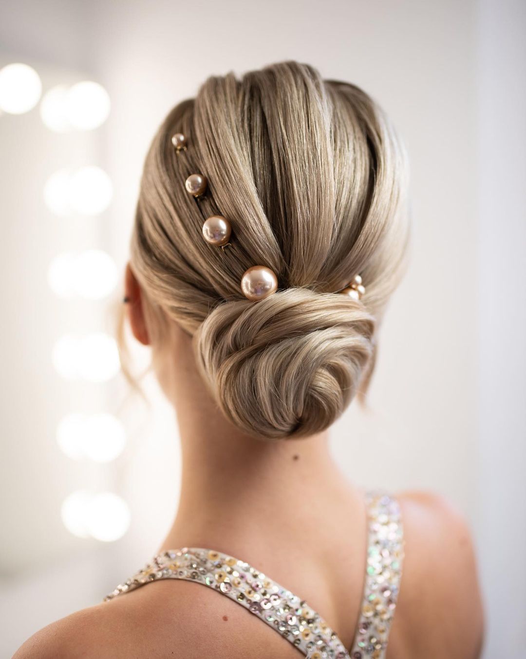 low bun updo hairstyle with' pearls via beautybyrockagirl