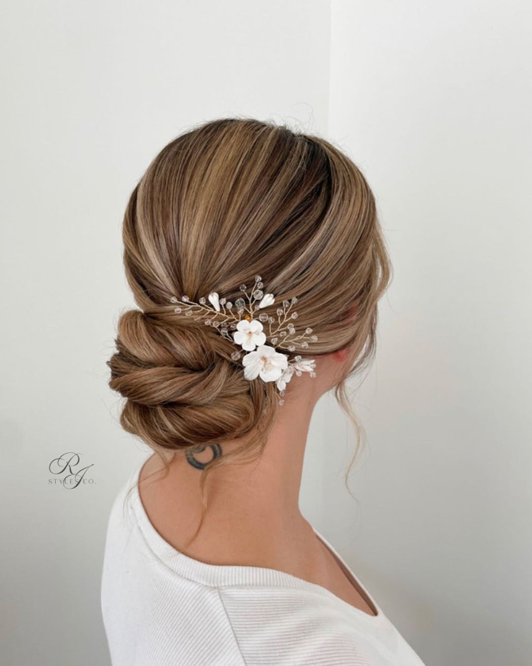 low bun updo wedding hairstyle with hair piece via rjstylesco
