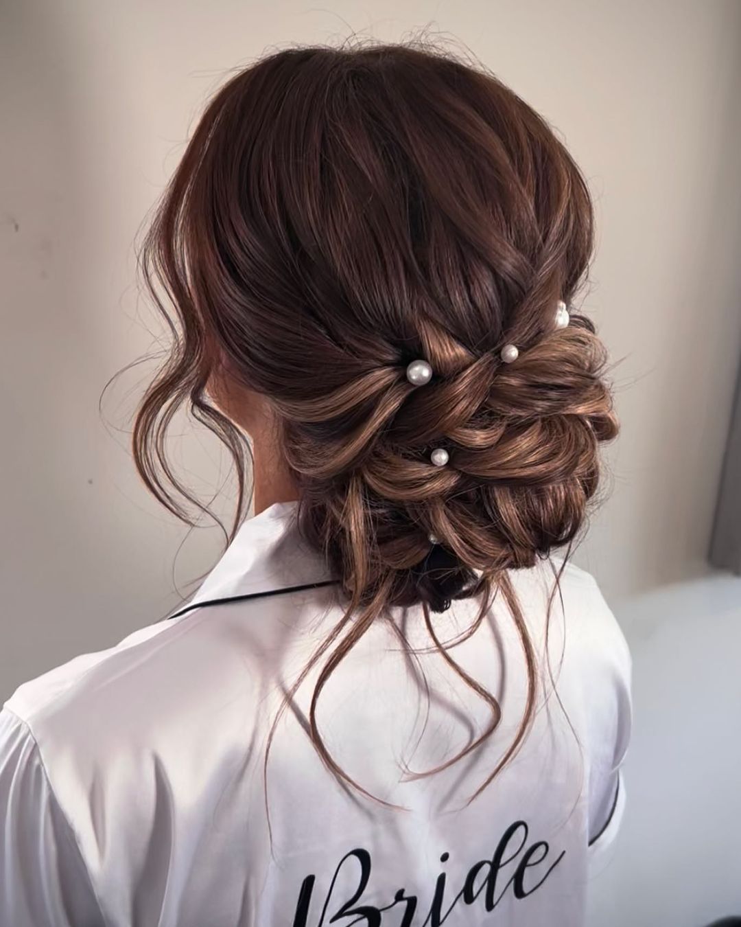 messy low bun wedding hairstyle with pearls via lisamariehair
