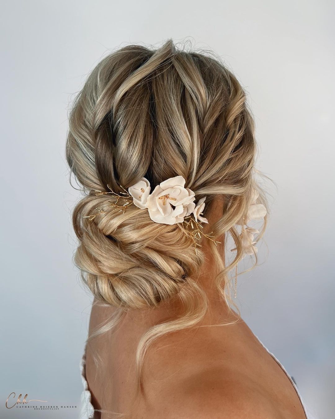 messy twisted low bun hairstyle for wedding via cathrineheierenhansen