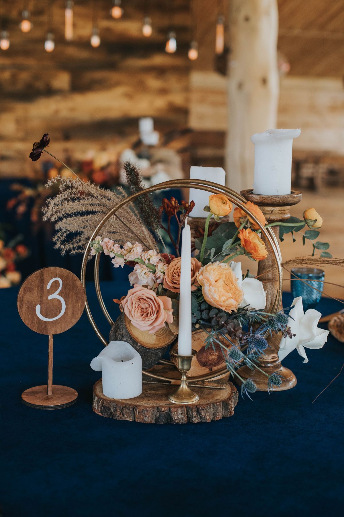 rustic bohemian circle and tree stump wedding centerpiece