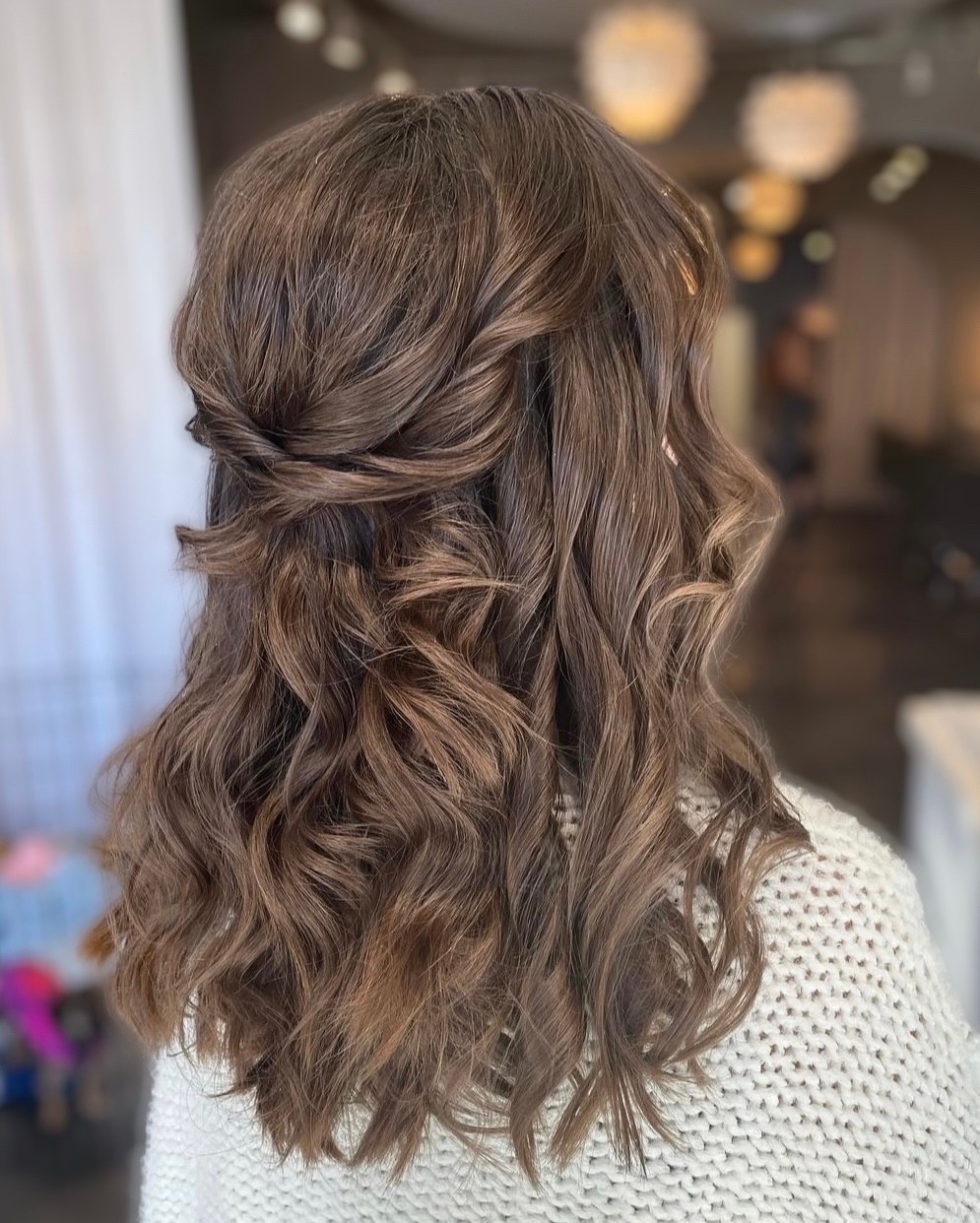 twisted half up half down medium length bridesmaid hairstyle