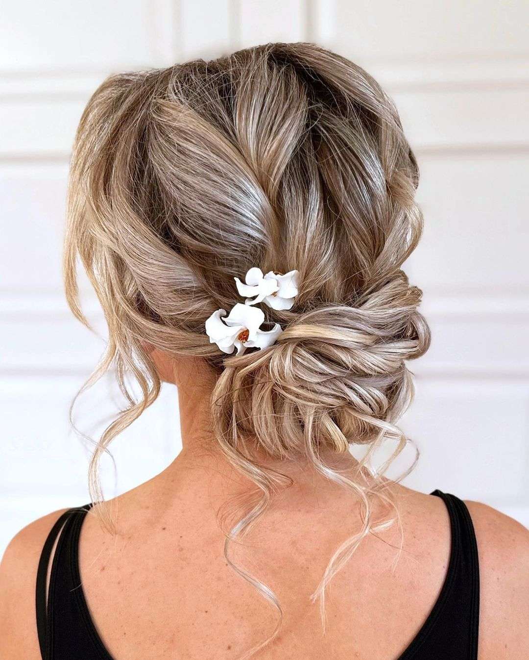 twisted messy low bun hairstyle for wedding via kimannesley.hair