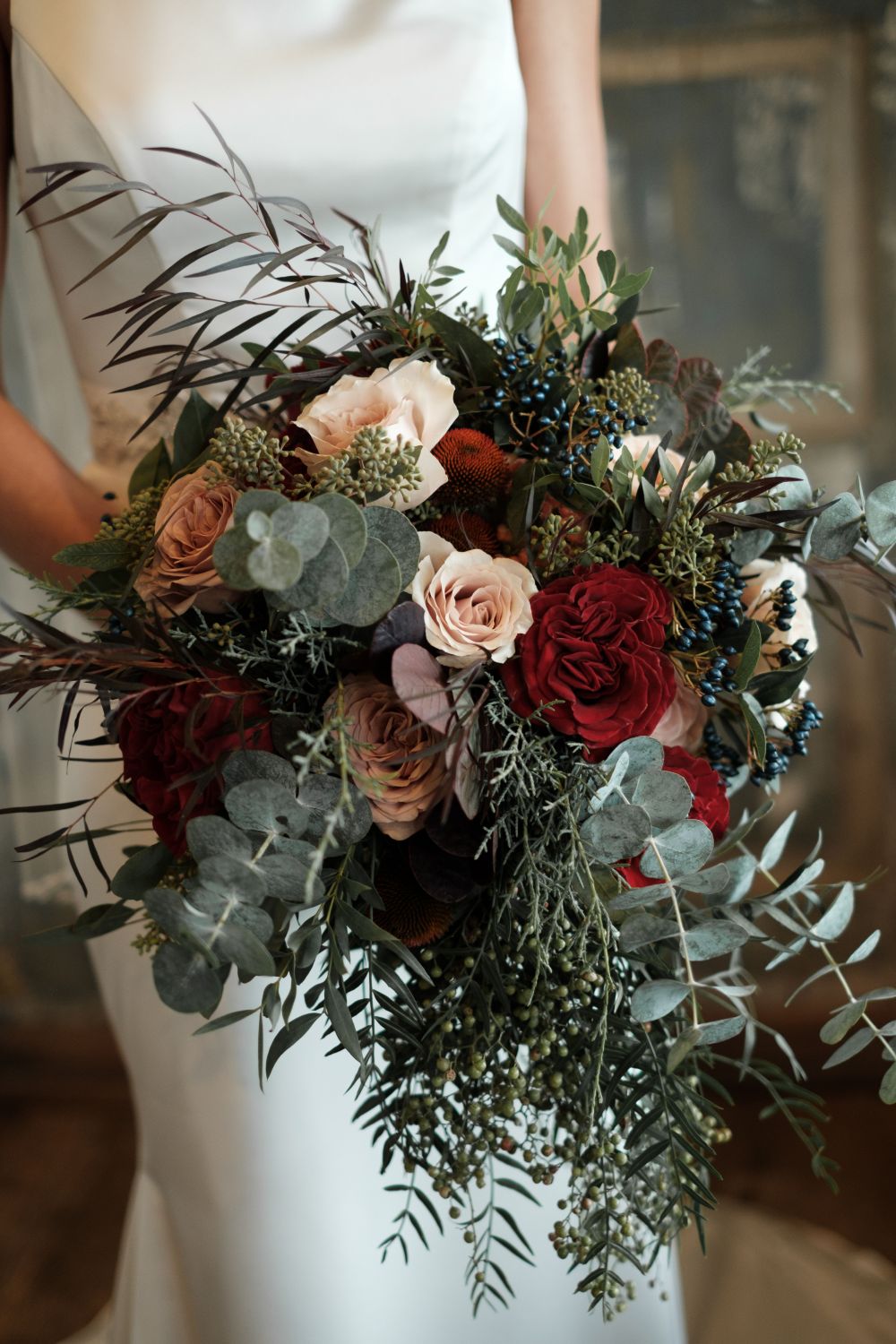 rustic red peach and green winter wedding bouquet